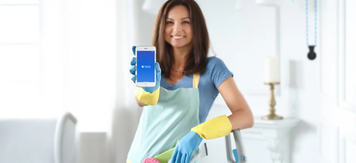 A lady vendor holding a phone, showing Know Your Customer App open on screen 